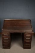 A 20th century oak tambour roll top desk, the desk opening to reveal an assortment of drawers and