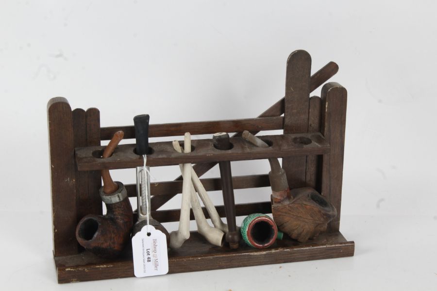 Novelty oak pipe rack, in the form of a gate, with a collection of pipes, the rack 28cm wide