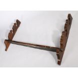 18th Century oak spit rack, the shaped sides above the shelf, 78.5cm high, 131cm wide