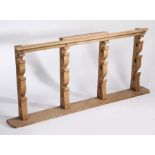 19th Century pine spit rack, the four arched supports with a plinth top and shelf base, 164cm