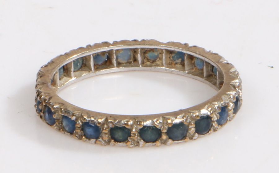 A yellow metal and sapphire eternity ring, ring size Q weight 2.3 grams
