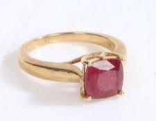 A 9 carat gold and ruby ring, the head set with a claw mounted cushion cut ruby, ring size N 1/2