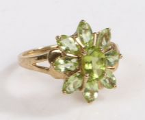 A 9 carat gold and peridot ring, the head in the form of a flower set with claw mounted oval