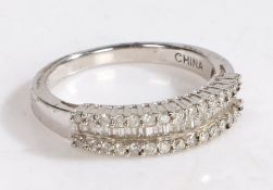 A diamond and silver ring, the head set with three rows of diamonds the center row of baguette cut