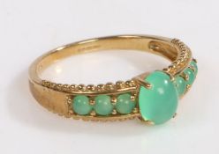 A 9 carat gold ring, the head set with seven opaque green stones, ring size O weight 2.2 grams