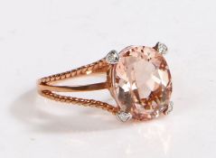 A 9 carat rose gold, diamond and kunz morganite ring, the head set with a oval kunz morganite and