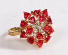 A 9 carat gold, diamond and tanzanian ruby cluster ring, the head in the form of a flower set with