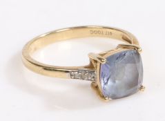 A 10 carat gold ring, the head set with a claw set asscher cut blue stone with three diamonds set to