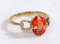 A 9 carat gold, diamond and andesine ring, the head set with an oval claw mounted andesine with