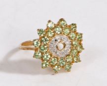 A 9 carat gold, diamond and ambanja demantoid ring, the head set with ring of diamonds surround by