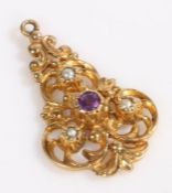 A 9 carat gold art nouveau pendant, set with a central amethyst and three pearls, weight 3.1 grams