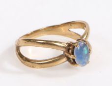 A 9 carat gold and opal ring, the head set with a claw mounted oval opal with bands forming the