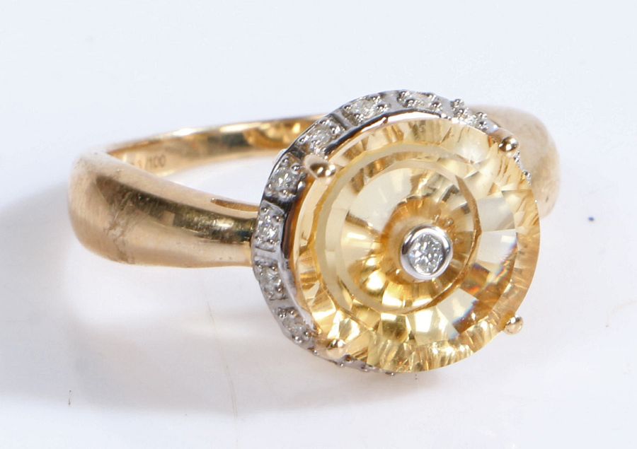 A 10 carat gold Citrine and diamond ring, the head set with a central diamond surrounded by a