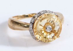 A 10 carat gold Citrine and diamond ring, the head set with a central diamond surrounded by a