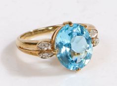 A 9 carat gold, diamond and aquamarine ring, the head set with a oval claw mounted aquamarine