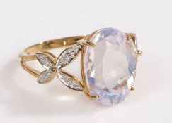 A 9 carat gold, diamond and lavender quartz ring, the head set with a claw mounted oval lavender