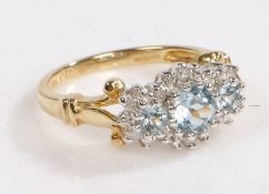 A 10 carat gold, aquamarine and diamond ring, the head set with three brilliant cut aquamarine