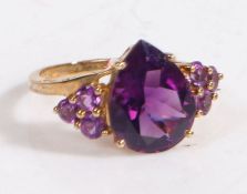 A 9 carat gold and amethyst colour stone ring, the head set with pear shape stone and three to