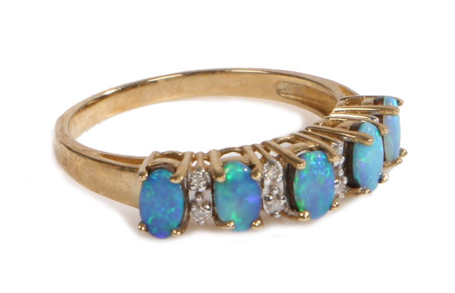 A 9 carat gold, opal and diamond ring, the head set with five claw mounted oval opals with