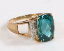 A 9 carat gold, diamond and Caribbean blue apatite ring, the head set with claw mounted Caribbean