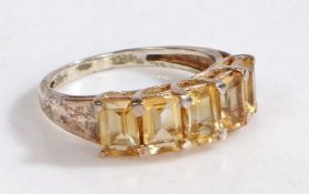 A silver and citrine ring, the head set with five claw mounted baguette cut citrines, ring size N