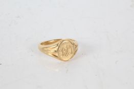 A gold signet ring, marks partiality rubbed, with monogrammed lettering to the head,  ring size V