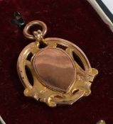 9 carat gold pocket watch chain pendant, with pierced scrolled border and central vacant inverted