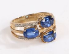 A 9 carat gold, diamond and kyanite ring, the head set with three offset claw mounted oval kyanite
