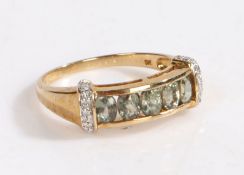 A 9 carat gold and diamond ring, the head set with five oval stones with a band of diamonds to