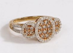 A 9 carat gold and diamond ring, the head set with many diamonds in three main sections together
