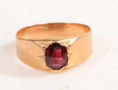 A yellow metal and garnet ring, the head set with a single oval garnet, ring size P weight 2.7 grams