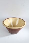 Large terracotta dairy bowl, having a cream and brown glazed interior, 48cm diameter 25cm high