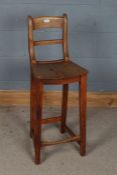 Victorian elm seated high stool, having bar back rest, square tapering legs united by stretchers,