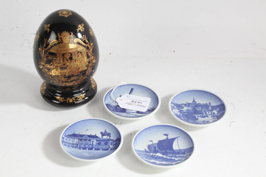 Four Royal Copenhagen small blue and white hanging dishes depicting a boat, windmill and landscape