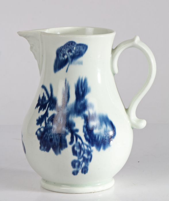 First Period Worcester jug, with mask moulded spout and scroll handle, the body with blue blurred