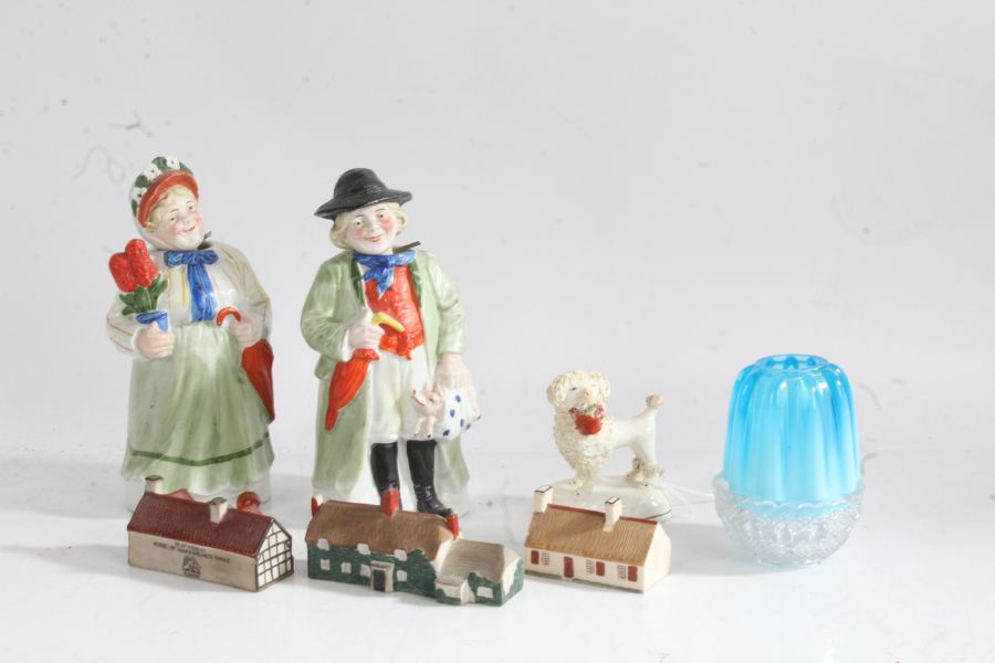 Porcelain and glass to include two nodding figures modelled as a rural gentleman carrying a pig in a