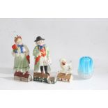 Porcelain and glass to include two nodding figures modelled as a rural gentleman carrying a pig in a