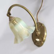 Brass desk lamp, with frilled opaline glass shade above an adjustable curved arm and scroll
