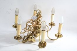 Brass six branch electric chandelier, with scrolled arms, four brass adjustable electric wall lights