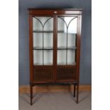 Edwardian mahogany and boxwood strung display cabinet, having a pair of astragal glazed doors with