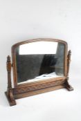Edwardian oak dressing table mirror, the arched mirror plate raised on twist carved supports and