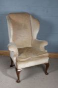 18th century style wing back armchair, having out swept arms and raised on cabriole legs, 124cm