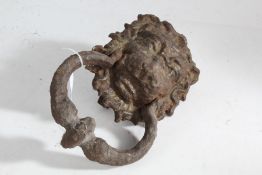 A George III style door knocker modelled as a lion with a ring to the mouth, 23cm high 15cm wide