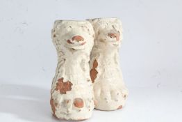 Pair of 19th century glazed terracotta stylised dogs, raised on paw feet, 17cm high (2)