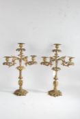 Pair of gilt metal three branch candelabra, the foliate cast sconces raised on pierced scroll cast