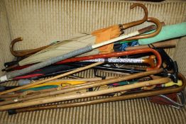 Large collection of walking sticks of various sizes and styles together with a African style spear