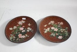 Pair of Japanese cloisonne plates, each with flora and birds on a red ground, 30.5cm diameter (2)