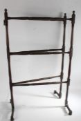 Edwardian mahogany folding towel rail, with turned uprights and horizontal bars, on turned feet,