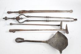Fire irons, to include scoop, two scrapers and two pairs of tongs (4)