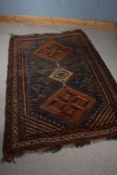 Afghanistan style rug, with a orange and blue ground with three diamond lozenges inset with